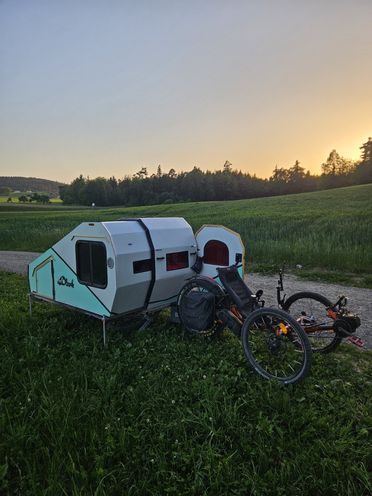 Velotark Fahrrad-Wohnwagen in der Natur bei Sonnenuntergang